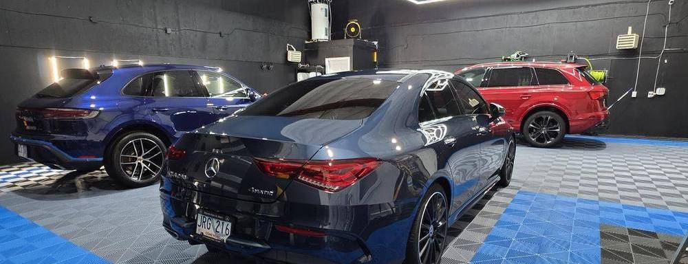 Inside the Swoosh Autodetailing shop with multiple vehicles being detailed